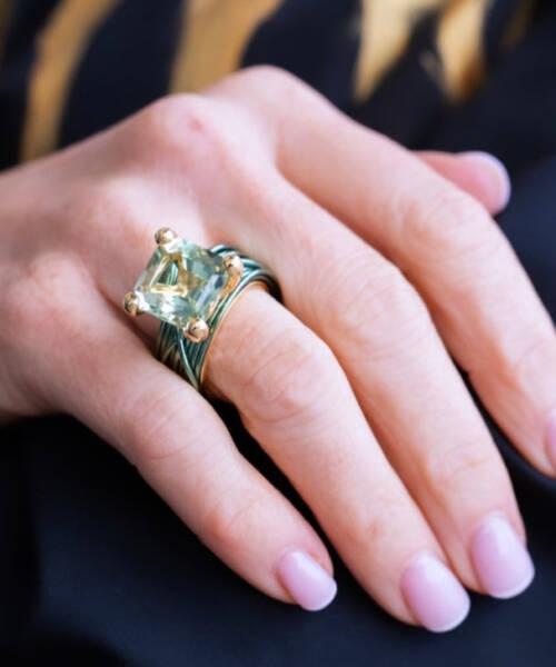 The wire ring with prasiolite and yellow gold