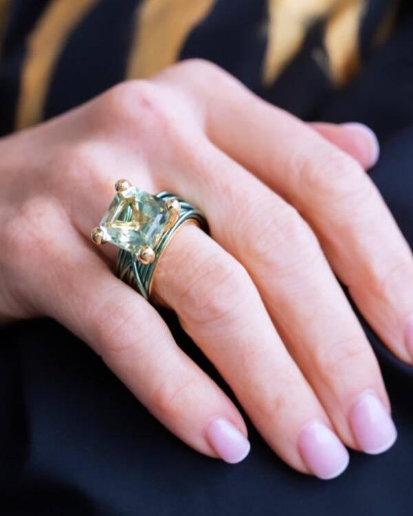 The wire ring with prasiolite and yellow gold